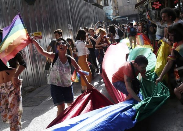 epa05377509 Participants carry rainbow flags as they gather in spite of the Istanbul LGTB Pride Parade being cancelled due to security concerns by the Governorate of Istanbul, in Istanbul, Turkey, 19 June 2016. Supporters of the LGBT community gathered in central Istanbul as part of the Trans Pride Week 2016.  EPA/SEDAT SUNA